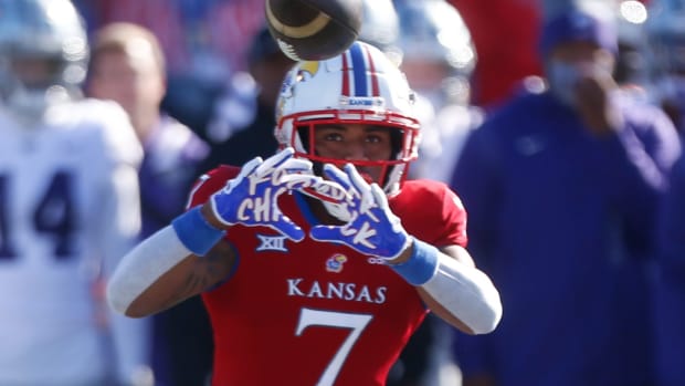Kansas redshirt sophomore Trevor Wilson (7) eyes a throw from redshirt junior Jason Bean in the first quarter of Saturday's Sunflower Showdown against Kansas State at David Booth Kansas Memorial Field.